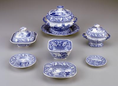 decorated with English views taken from paintings of English historical scenes; light blue transfers picture different scenes with the name of the scene on the reverse side; sometimes the wrong name identifies the picture; two pieces do not have names; large tureen cover pictures a windmill and fishermen; butter boat displays a small building